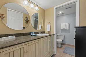 A bathroom with a sink, mirror, and toilet. - 809 | Refreshed Beachfront Escape—1BR, Balcony & FREE VIP Beach Service (Panama City Beach)