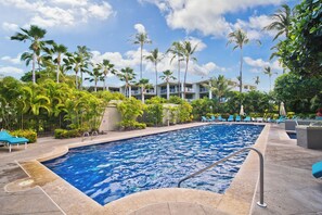 A swimming pool surrounded by palm trees and lounge chairs. - Tropical Elegance 2BR Condo; Beach/Golf/Shopping (Waikoloa Village)