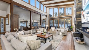 A spacious living room with a large sectional sofa, a coffee table, and a fireplace. - ✨ Soltierra • 🏔️ Breck Peak 8 • 🎿 Ski-In • 💦 10-Person Spa • 🛏️ 13 Beds (Breckenridge)