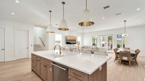 A modern kitchen with a large island, stainless steel appliances, and pendant lighting. - Pelayo Solage|Deeded Beach Access|Private Pool|Golf Cart & Bikes (Santa Rosa Beach)