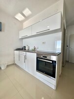 Deluxe Apartment, Balcony | Private kitchen | Full-size fridge, stovetop, cookware/dishes/utensils