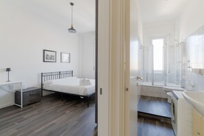 Ein Schlafzimmer mit Bett, Nachttisch und Beistelltisch.