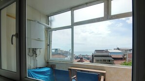 A room with a large window, a bed, a table, and a chair. - In the Center of Ancient Lands-2 (İstanbul)