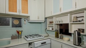 A kitchen with white cabinets, a built-in stove, and a dishwasher. - In the Center of Ancient Lands-2 (İstanbul)