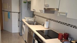 A modern kitchen with stainless steel appliances, a built-in oven, and a large countertop. - APT Astigarraga 2H 1C (Gipuzkoa) (Astigarraga)