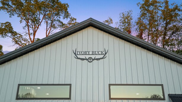 A building with a sign reading "Ivory Buck" and two windows.