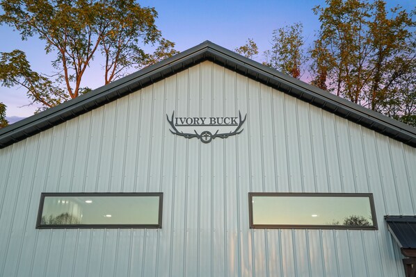 A building with a sign reading "Ivory Buck" and two windows.