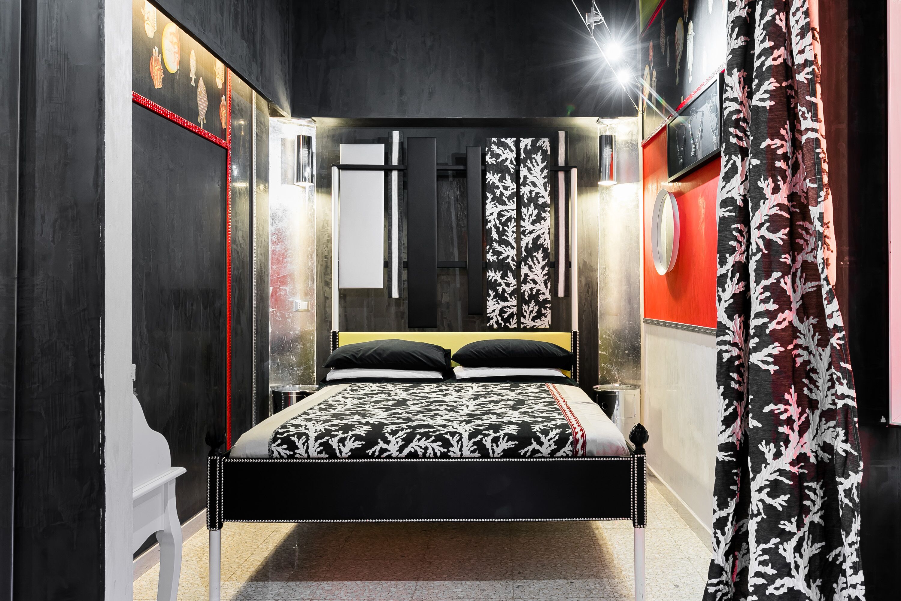 A modern bedroom with a bed, a nightstand, and a wardrobe.