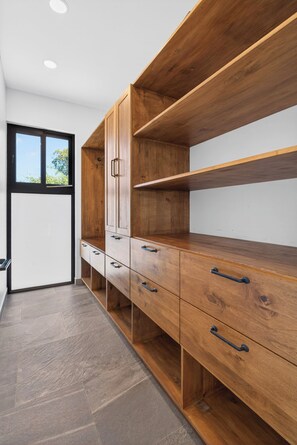 Een modern interieur met een houten kast, een raam en een betegelde vloer.