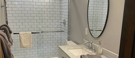 Shower, hair dryer, towels, toilet paper