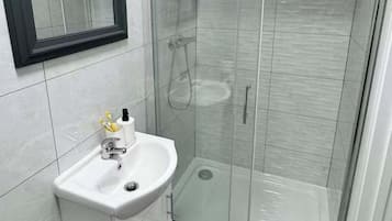 Shower, hair dryer, towels, shampoo