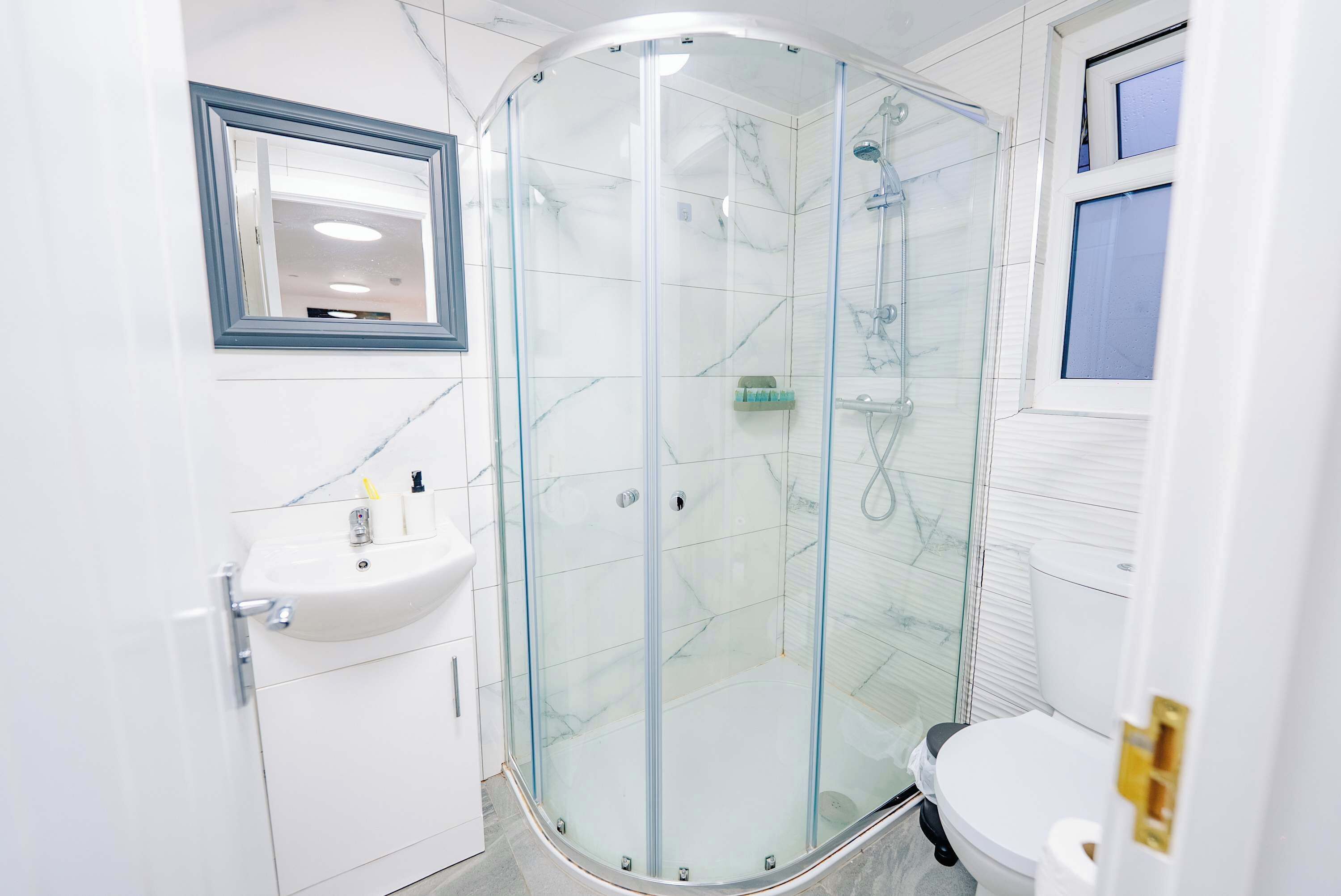 Shower, hair dryer, towels, shampoo