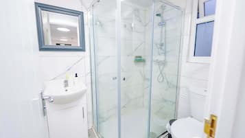 Shower, hair dryer, towels, shampoo