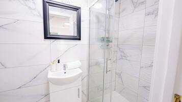 Shower, hair dryer, towels, shampoo