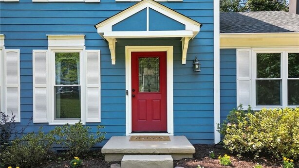 A blue house with a red door, white shutters, and a small porch. - Perfect Location, Minutes to everything Alpharetta & Johns Creek (Alpharetta)