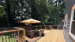 A wooden deck with outdoor furniture and a large umbrella. - Perfect Location, Minutes to everything Alpharetta & Johns Creek (Alpharetta)