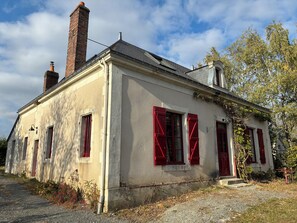 A two-story building with red shutters, a brick chimney, and a gravel driveway. - House (12 people) in Jupilles, between Le Mans and Tours, 28km from the Circuit. (Jupillles)