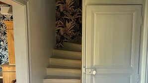 A staircase with a decorative wall and a door.