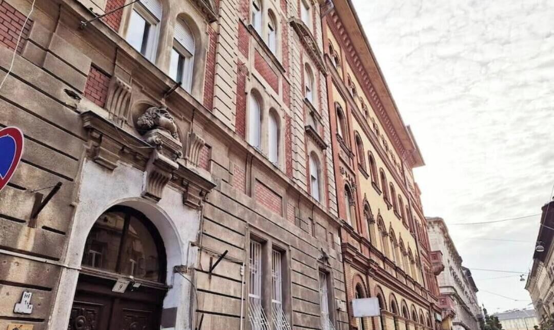 A historic building with arched windows and a stone facade.