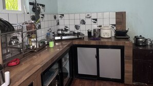 A kitchen with a wooden countertop, a stove, and a sink. - Chipaskot Spot (Pokhara)