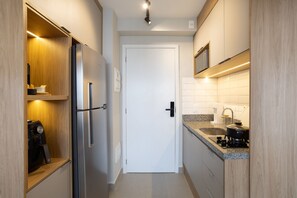 City appartement | Privékeuken | Een kookplaat, kookgerei, borden en bestek