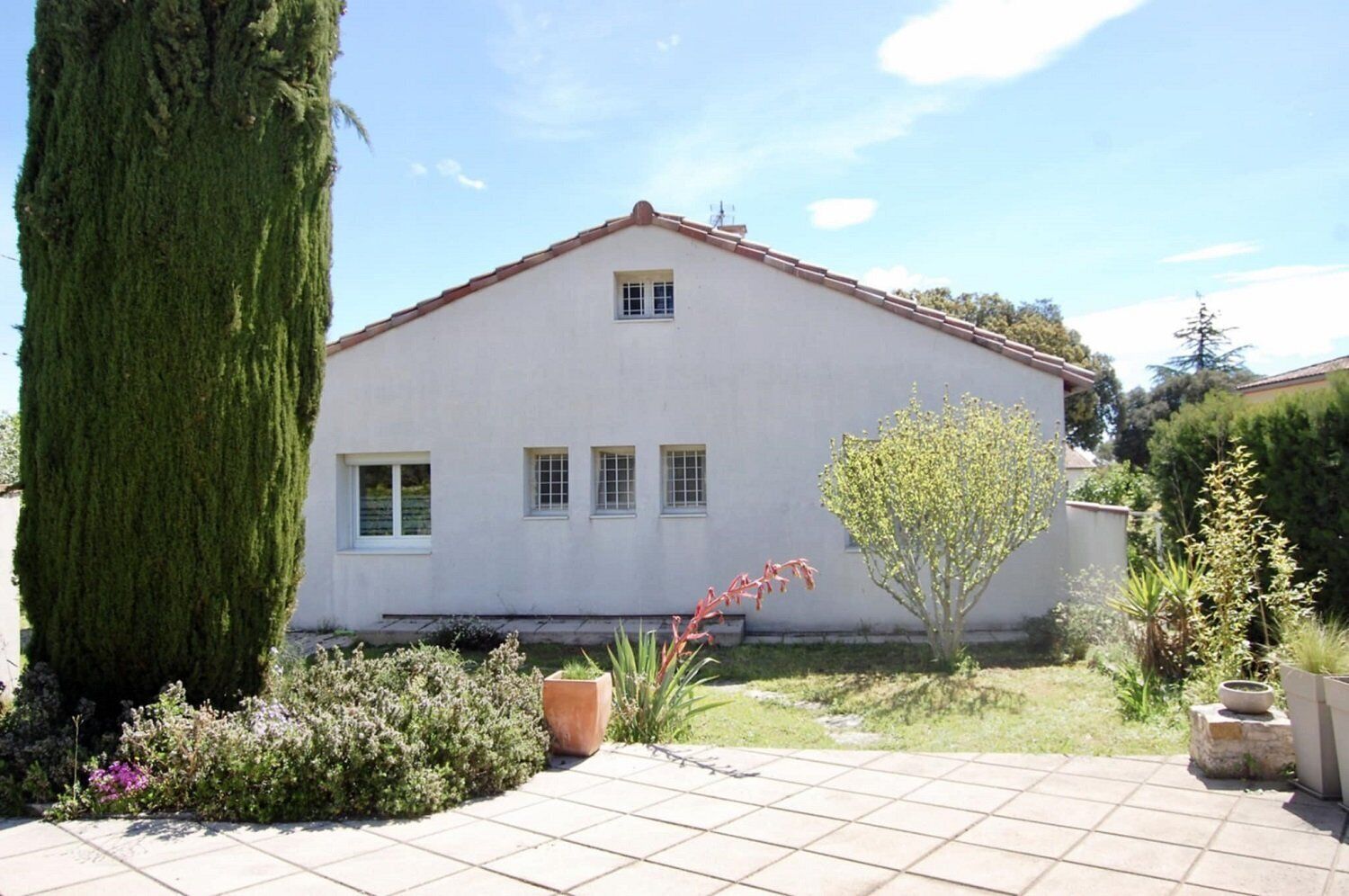 A single-story building with a flat roof and a small window on the front.
