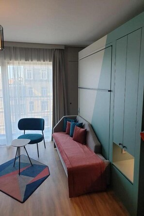 Ein modernes Wohnzimmer mit einer Couch, einem Sessel und einem kleinen Tisch.