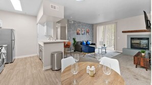 A modern living space with a kitchen, dining area, and seating area.