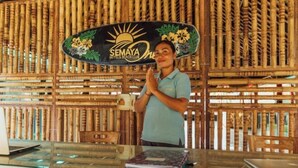 A reception area with a bamboo wall and a sign for Semaya Hotels & Beach Club. - Semaya One Beach Hotel (Bali)