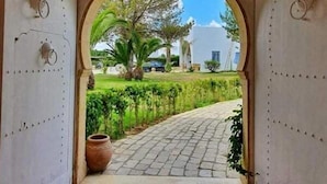 An arched exit doorway with a sign indicating "EXIT". - Ecrin Club  (Hammamet)