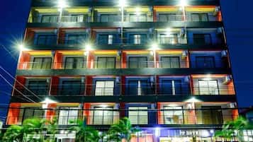 A multi-story hotel with illuminated balconies and a visible entrance labeled 'PPT HOTEL'.