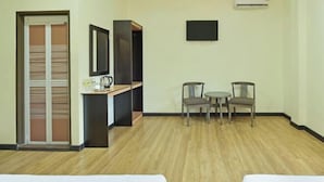 A hotel room with a wooden floor, a desk with a chair, a TV on the wall, and a bed. - Hotel O Pendang Lake Formerly D Jiwa (Pendang)