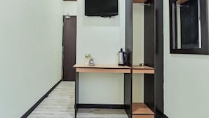 A narrow hallway with a wooden desk, a black-framed mirror, and a black door. - Hotel O Pendang Lake Formerly D Jiwa (Pendang)