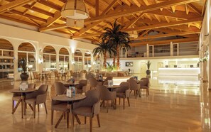 A spacious lobby with high ceilings, wooden beams, and a reception desk. - Ilunion Sancti Petri (Chiclana de la Frontera)