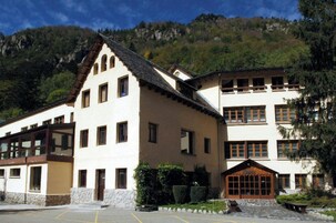 A building with a traditional architectural style, featuring a prominent gabled roof and multiple windows.
