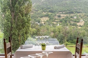 A table set for dining with a view of a lush landscape. - El Mirador (Puertolas)
