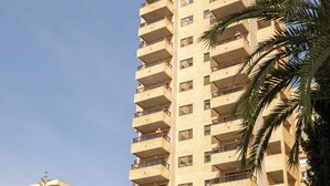 Un immeuble de grande hauteur doté de nombreux balcons et d’une enseigne indiquant « San Diego Apartments ».