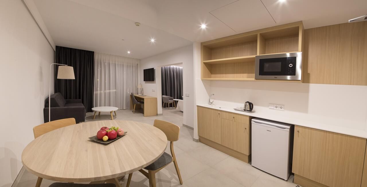 A modern kitchen with a microwave, dishwasher, and wooden cabinets.