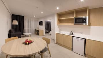 A modern kitchen with a microwave, dishwasher, and wooden cabinets.