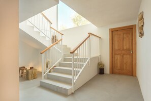 A staircase with wooden railings and white steps, leading to a wooden door. - Hacienda Fresneda María by Real Spain Hotels (Antequera)