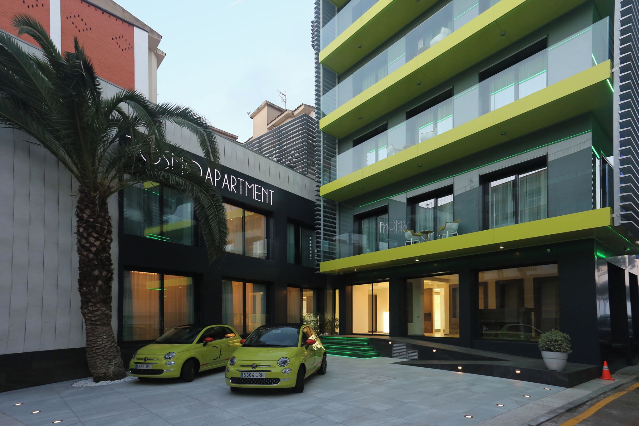 A modern building with a sign reading "RESIDENCE APARTMENT".