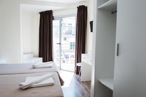 A hotel room with two beds, a balcony, a desk, and a chair. - Celymar (Benidorm)