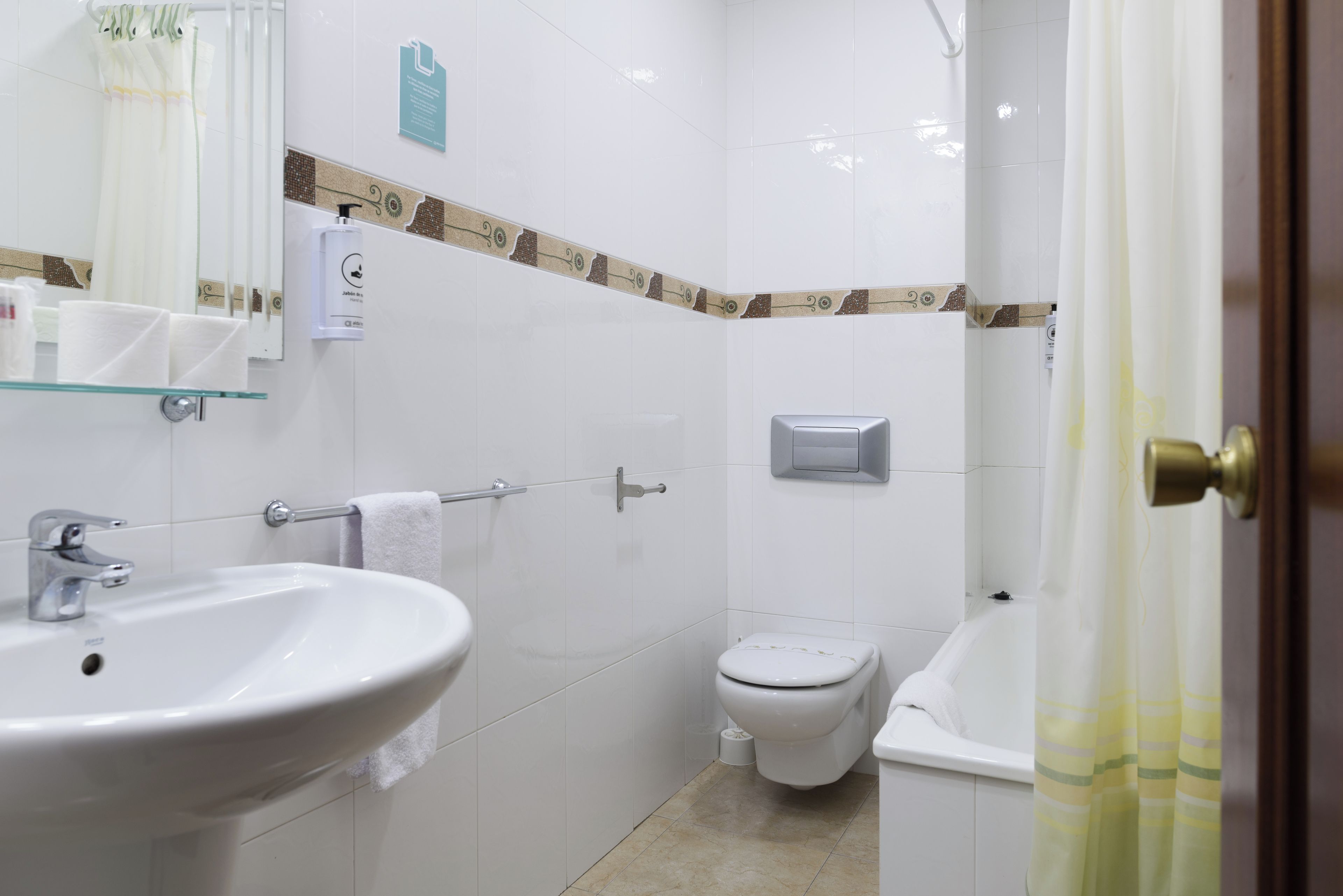 A bathroom with a sink, toilet, and bathtub.