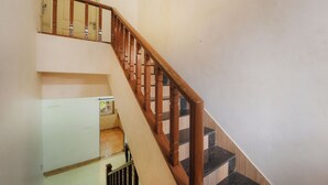 Eine Treppe mit Holzbalkonen und einer weißen Wand.