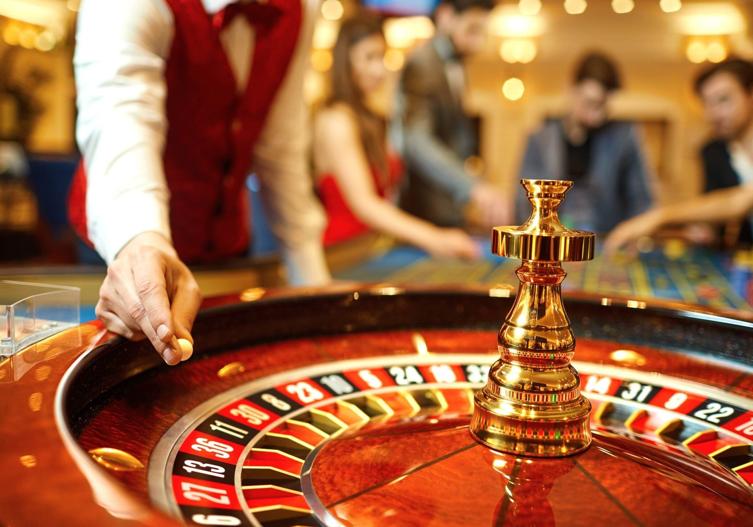 A roulette wheel with a hand spinning it.