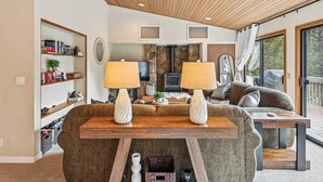 Ein gemütliches Wohnzimmer mit Kamin, Fernseher und einer bequemen Sitzecke.