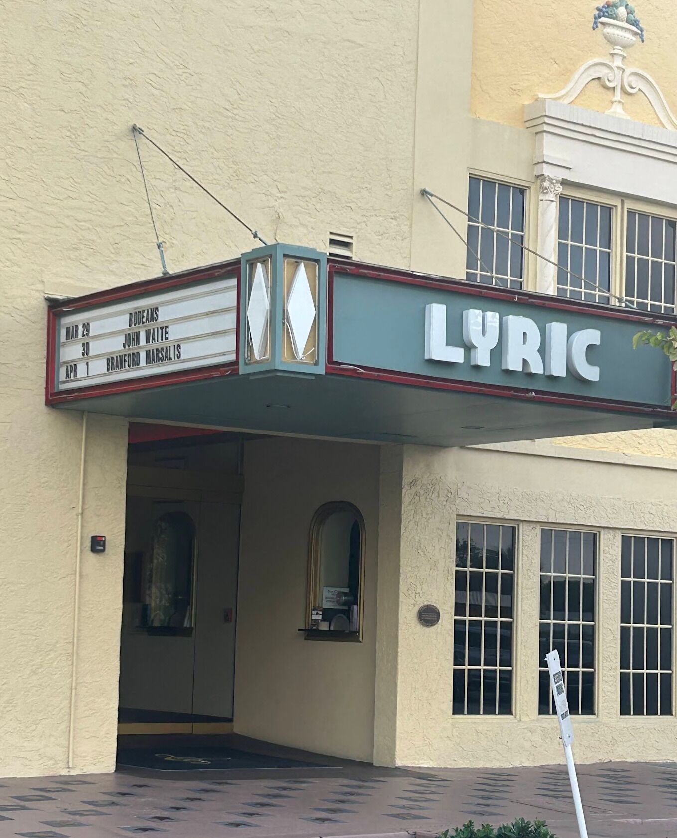Exterior entrance and marquee sign of the Lyric theatre building.
