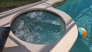 A swimming pool with a hot tub area. - Low Rates! Superb 4-bed Pool/Game Room Home Near Disney World Free Wi-fi & More (Kissimmee)