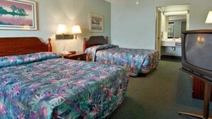 A hotel room with two beds, a television, and a painting on the wall. - Red Roof Inn Rockingham (Rockingham)