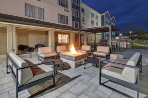 An outdoor patio with a fire pit, seating, and barbecue grills. - Staybridge Suites Pittsburgh Airport, an IHG Hotel (Pittsburgh)